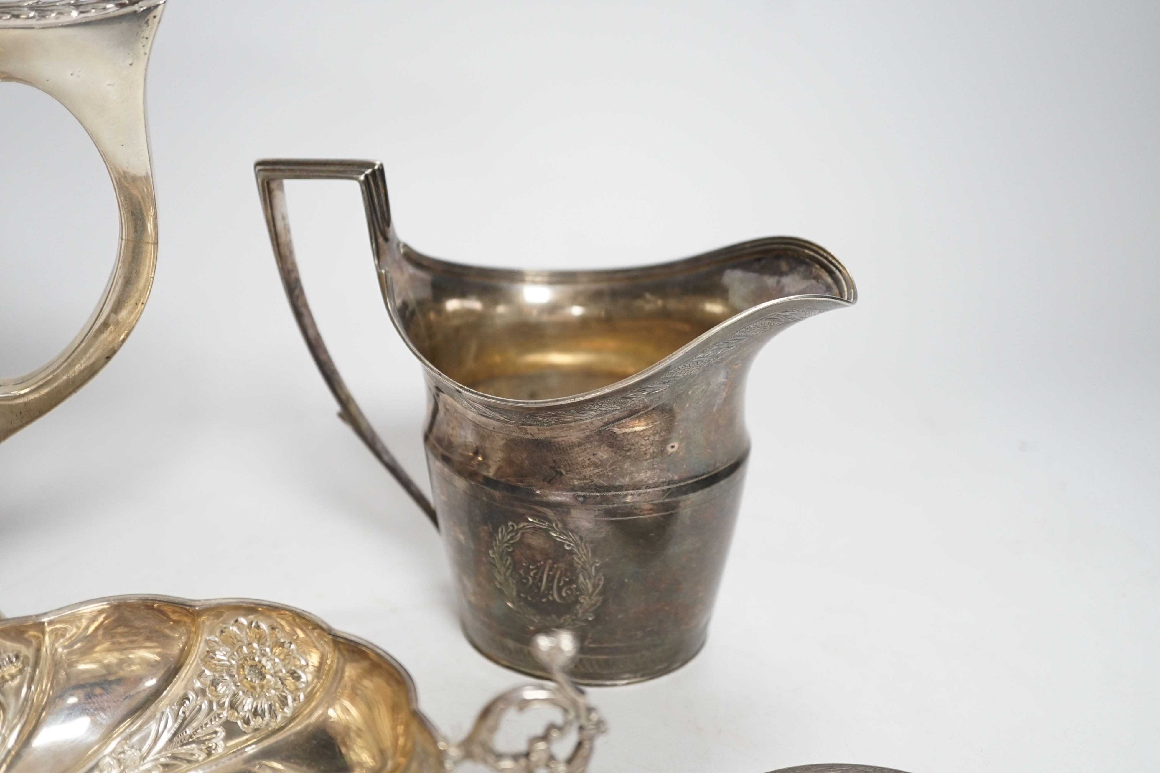 A George III engraved silver helmet shaped cream jug, John Eames, London, 1798, 11.1cm, a Japanese Suzuyo 950 white metal two handled shallow bowl, a George V silver two handled presentation trophy cup and a silver circu